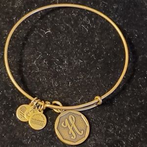 Alex and Ani brass tone bangle bracelet with H monogram charm